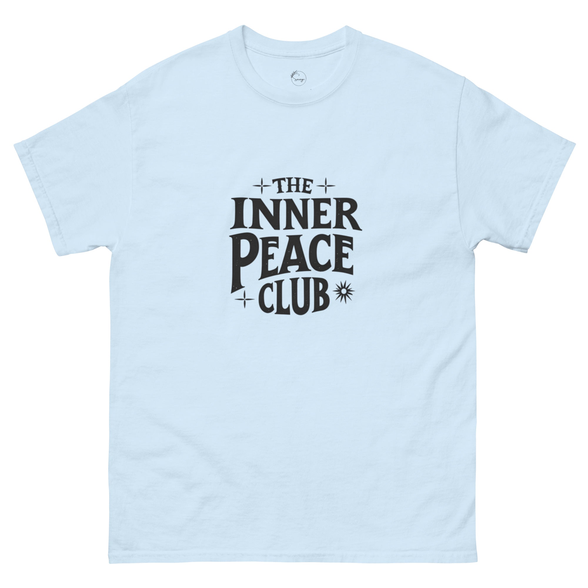 Flat lay of a cream-colored “The Inner Peace Club” t-shirt with soft lettering, styled with pastel accessories and cozy neutral tones.