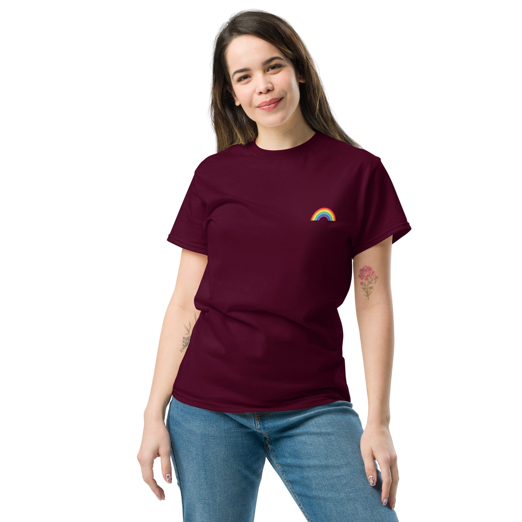 Woman wearing a maroon t-shirt with a rainbow design on a white background