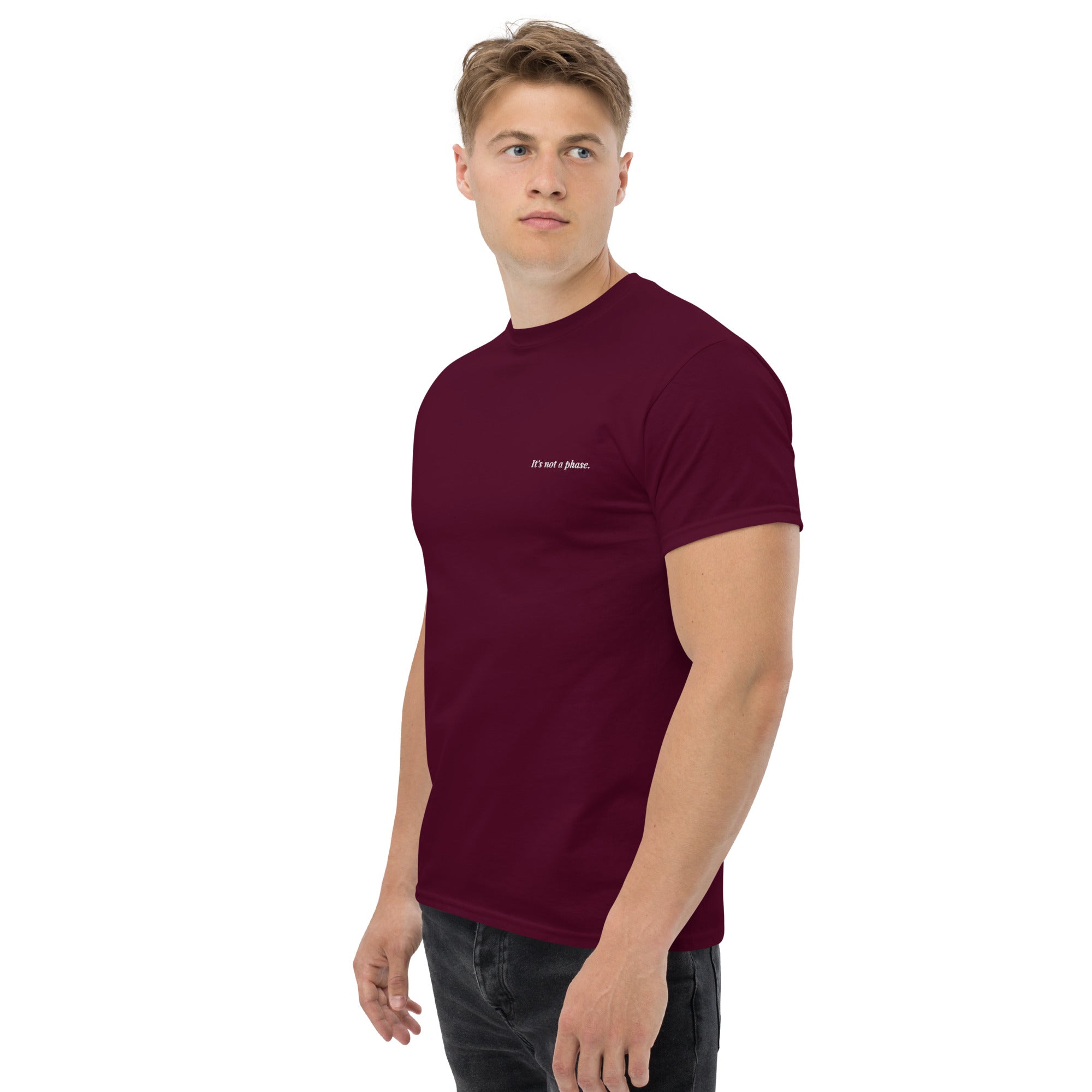 Man wearing a maroon t-shirt with a logo on a white background