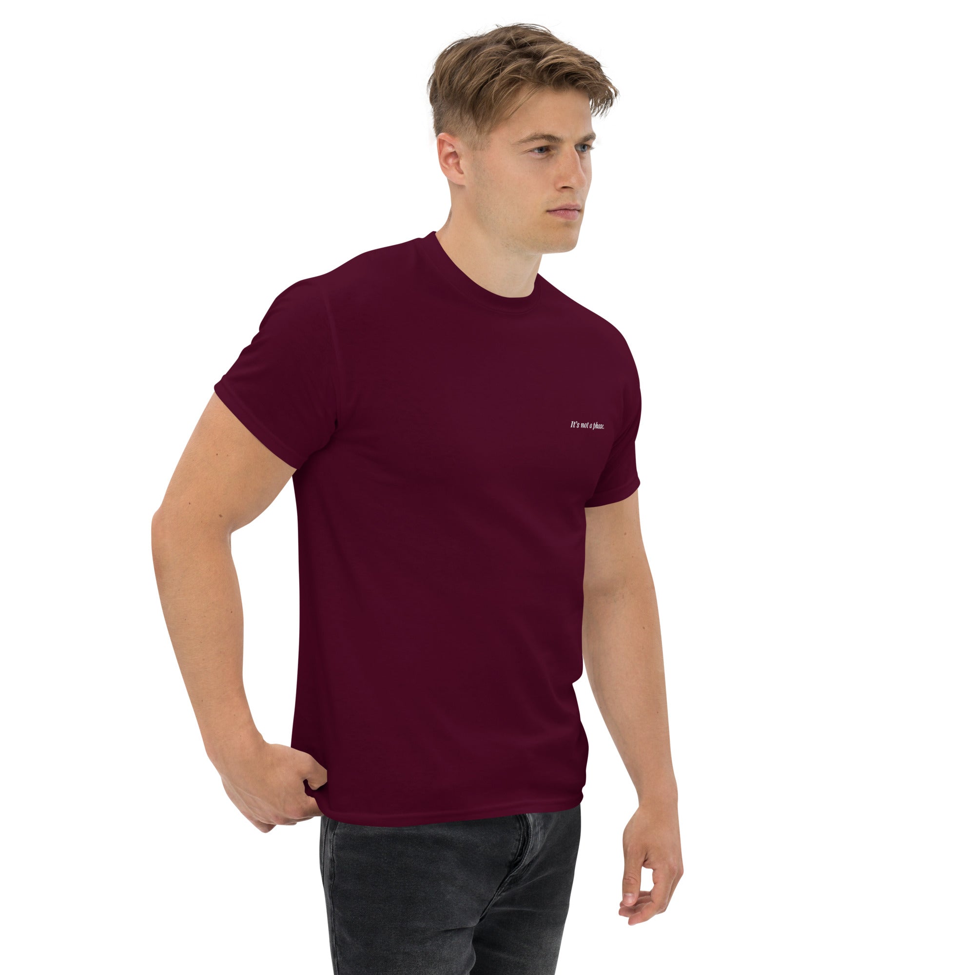Man wearing a maroon t-shirt with a logo on a white background