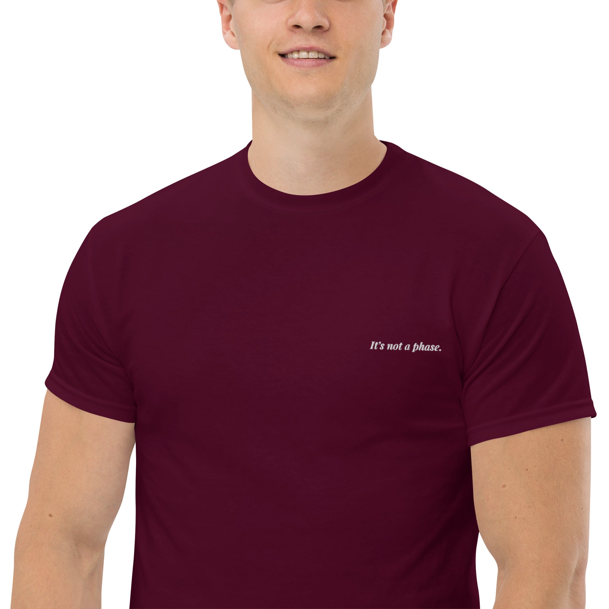 Man wearing a maroon t-shirt with text on a white background