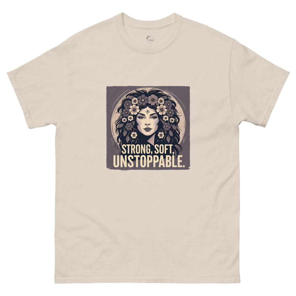 Beige t-shirt with a graphic of a woman with flowers and the text 'Strong, Soft, Unstoppable' on a white background.