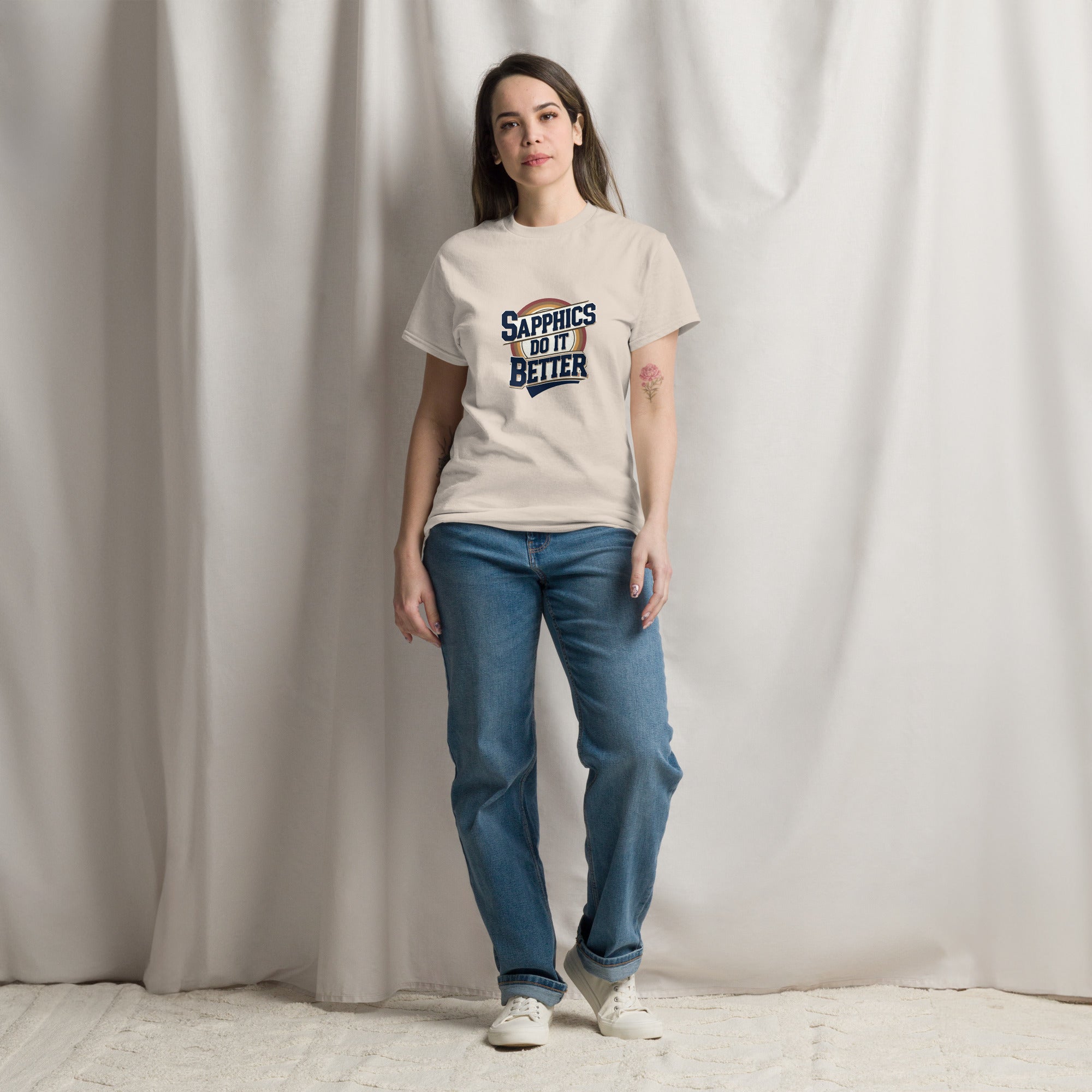 Person wearing a t-shirt with text standing against a plain background