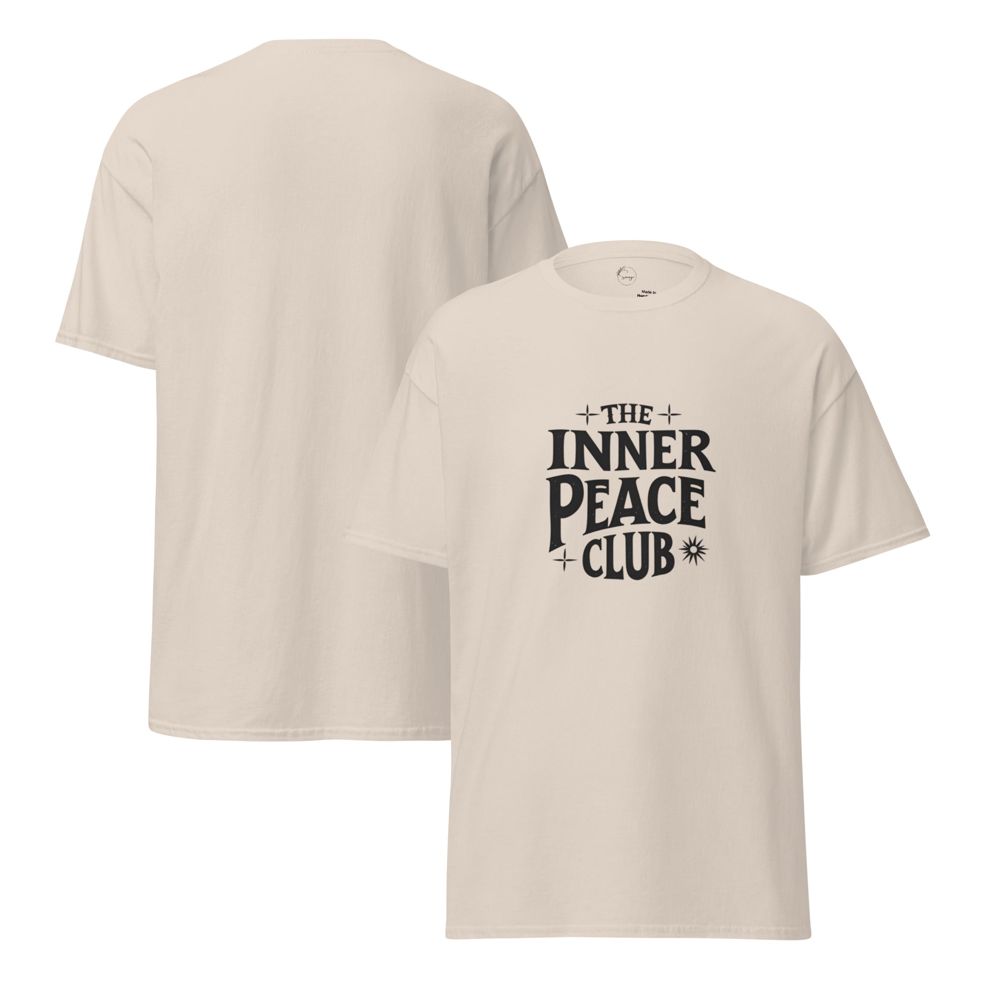 Flat lay of a cream-colored “The Inner Peace Club” t-shirt with soft lettering, styled with pastel accessories and cozy neutral tones.