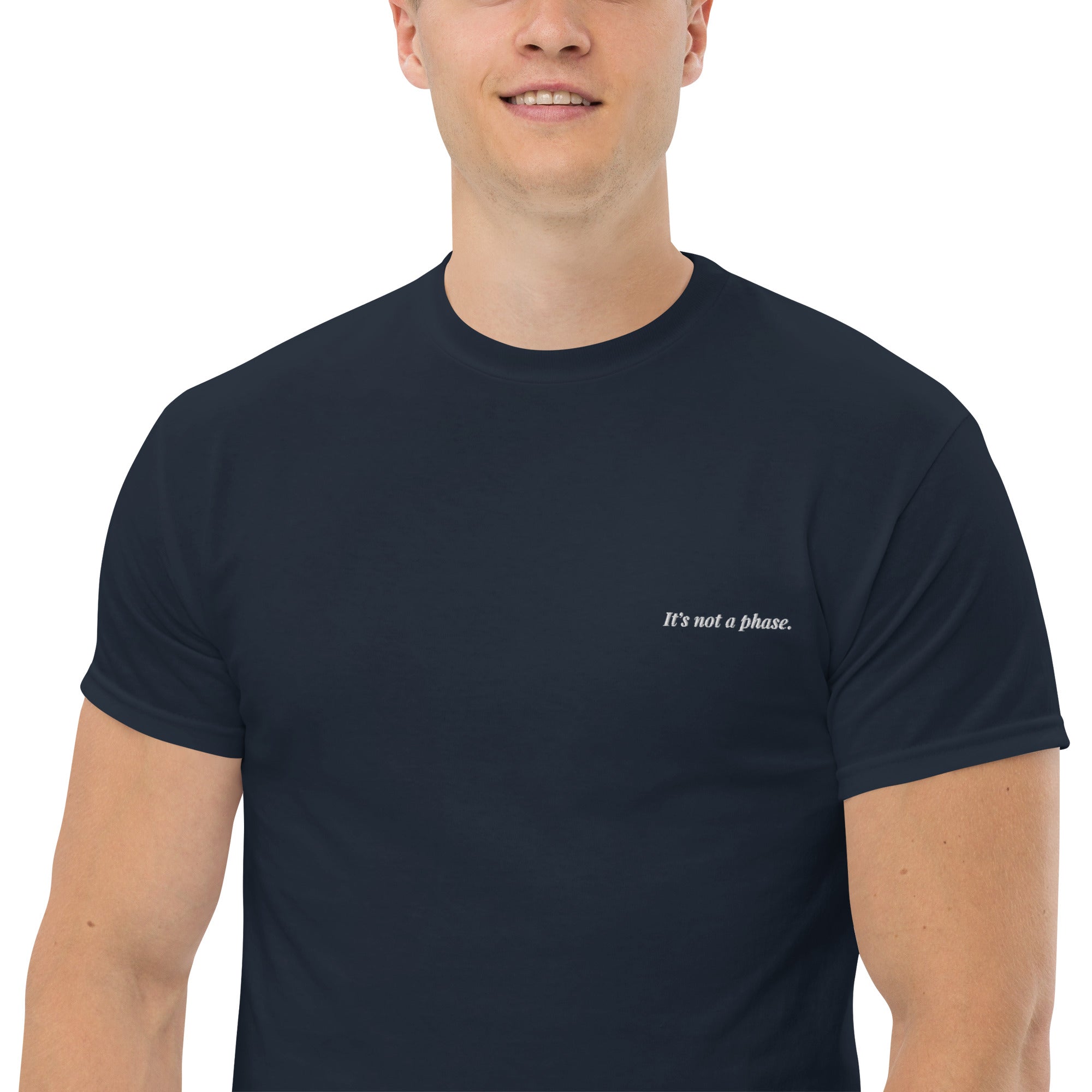 Man wearing a navy blue t-shirt with text on a white background