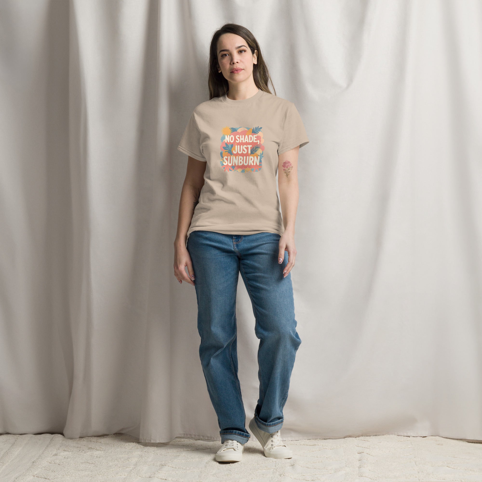 Model wearing No Shade, Just Sunburn slogan T-shirt by Savage Cotton in sunshine yellow, styled with sunglasses and a Pride flag