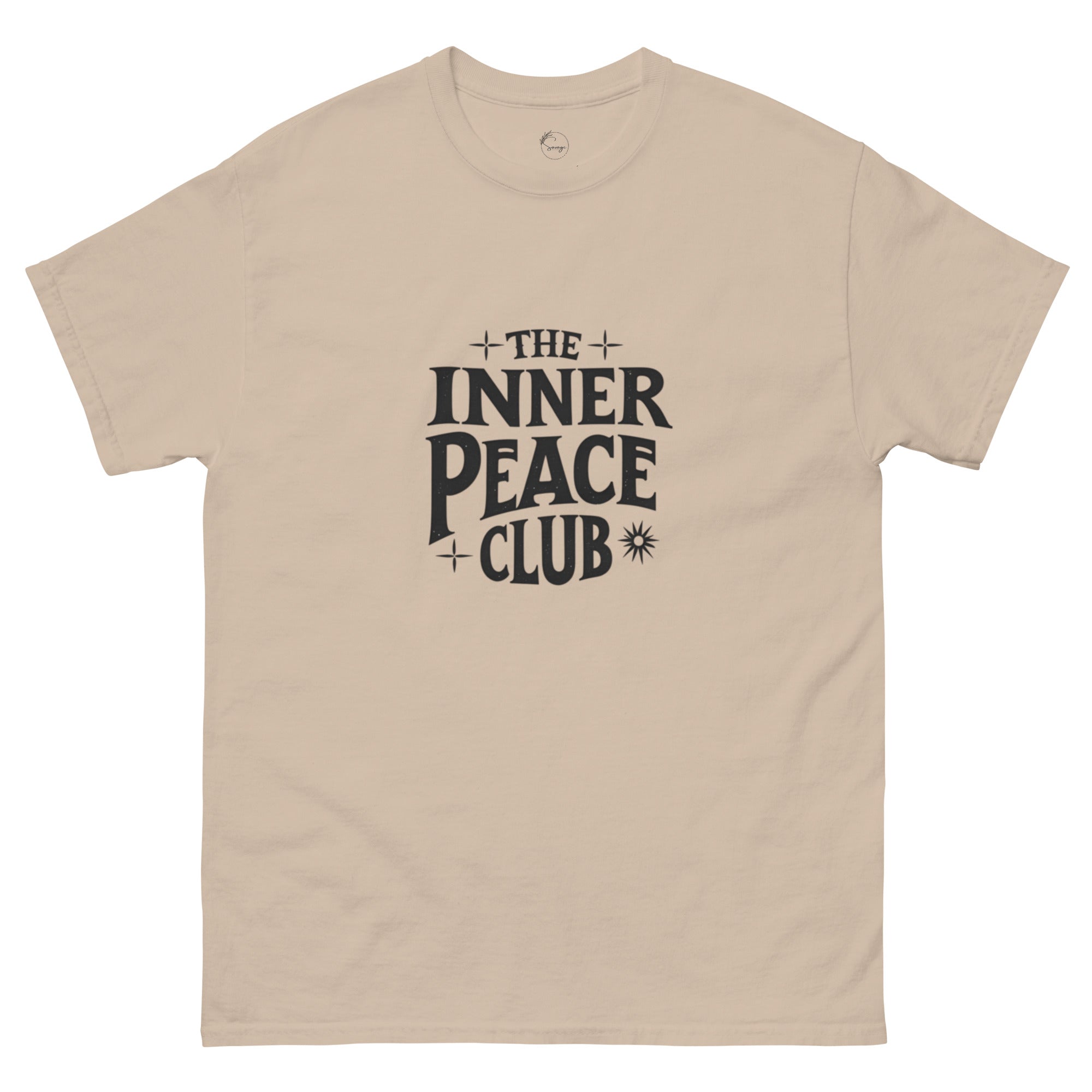 Flat lay of a cream-colored “The Inner Peace Club” t-shirt with soft lettering, styled with pastel accessories and cozy neutral tones.