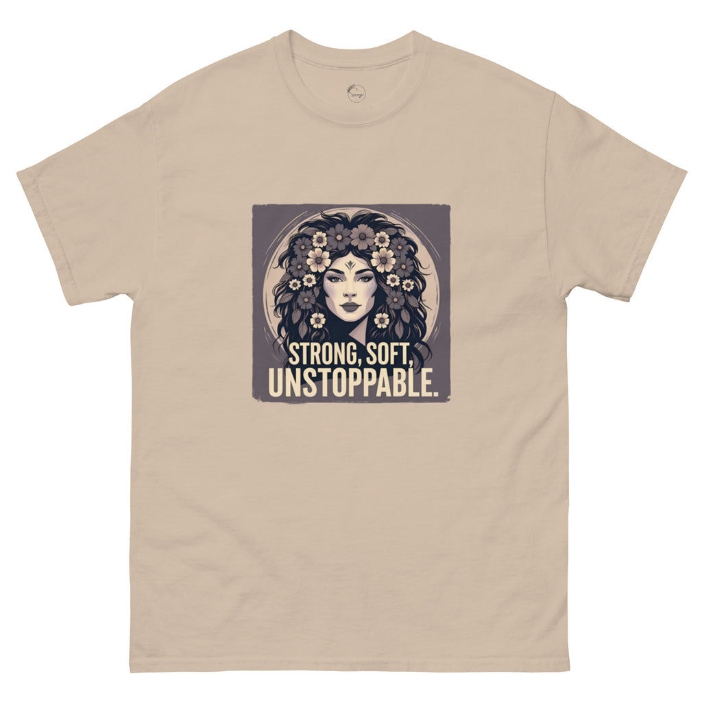 Beige t-shirt with a graphic of a woman with flowers and the text 'Strong, Soft, Unstoppable' on a white background.