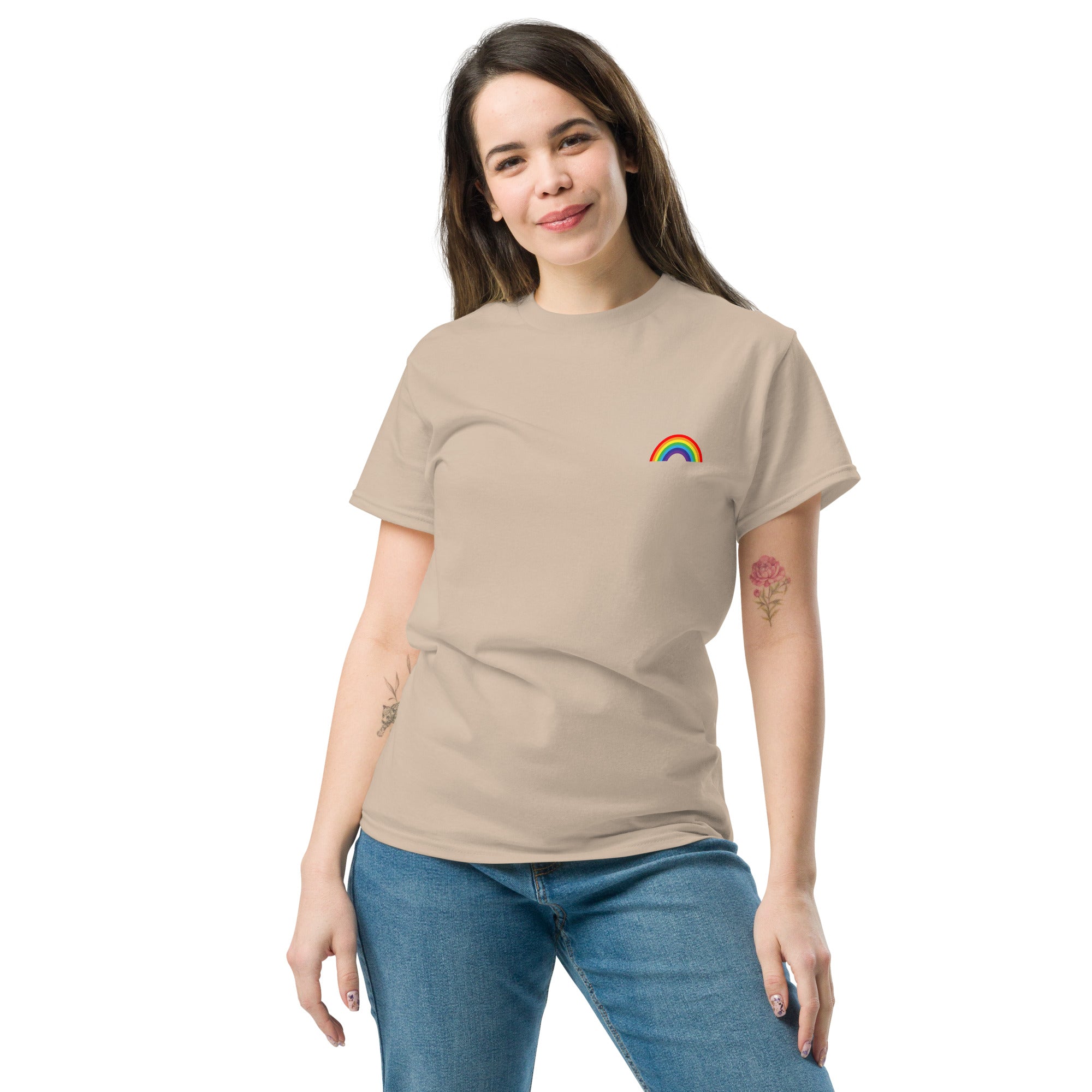 Woman wearing a beige t-shirt with a rainbow design on a white background