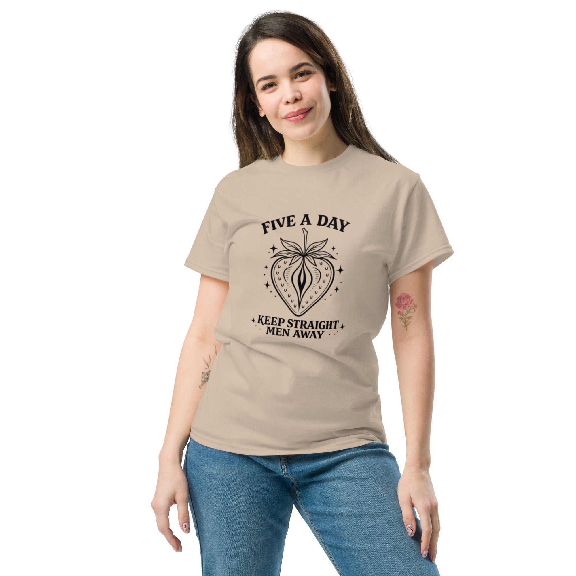 Woman wearing a beige t-shirt with a cartoon character design on a white background