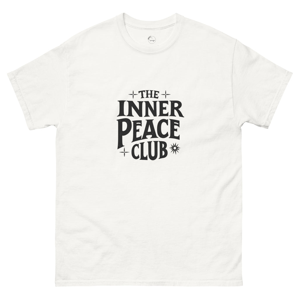 Flat lay of a cream-colored “The Inner Peace Club” t-shirt with soft lettering, styled with pastel accessories and cozy neutral tones.