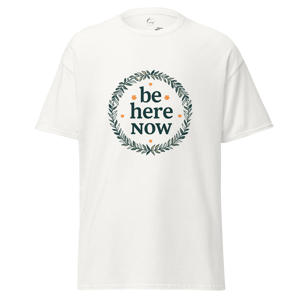 White t-shirt with 'be here now' text and wreath design on a white background