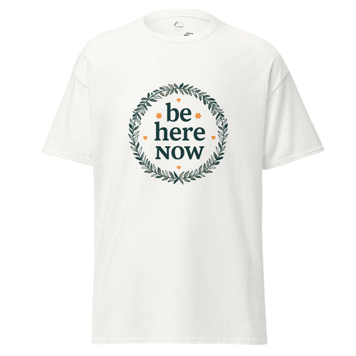 White t-shirt with 'be here now' text and wreath design on a white background