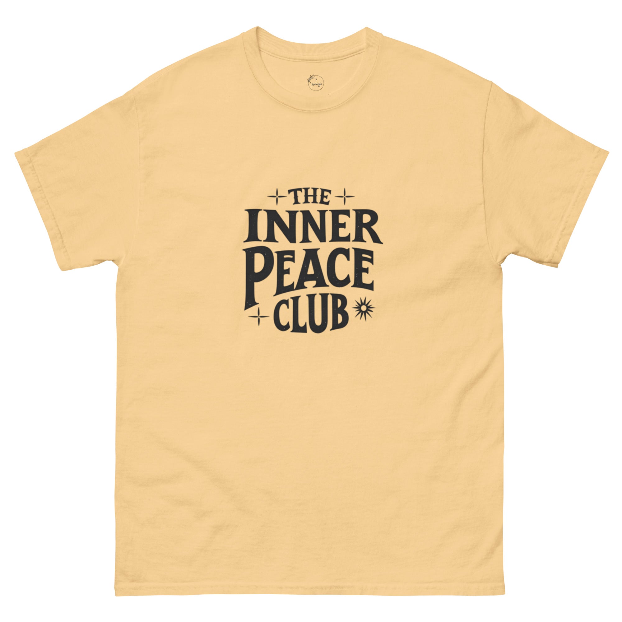 Flat lay of a cream-colored “The Inner Peace Club” t-shirt with soft lettering, styled with pastel accessories and cozy neutral tones.