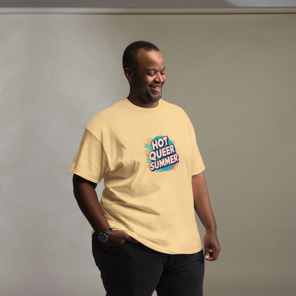 Man wearing a beige t-shirt with 'Hot Queer Summer' graphic design against a plain background