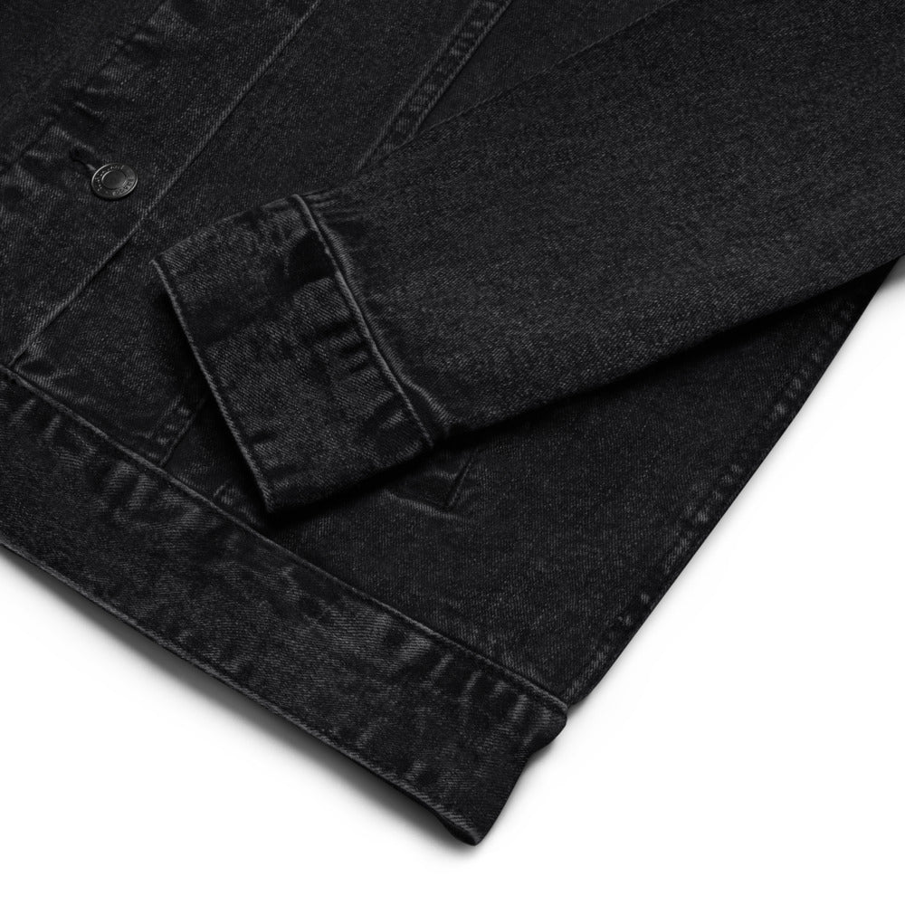 Close-up of a black denim jacket on a white background