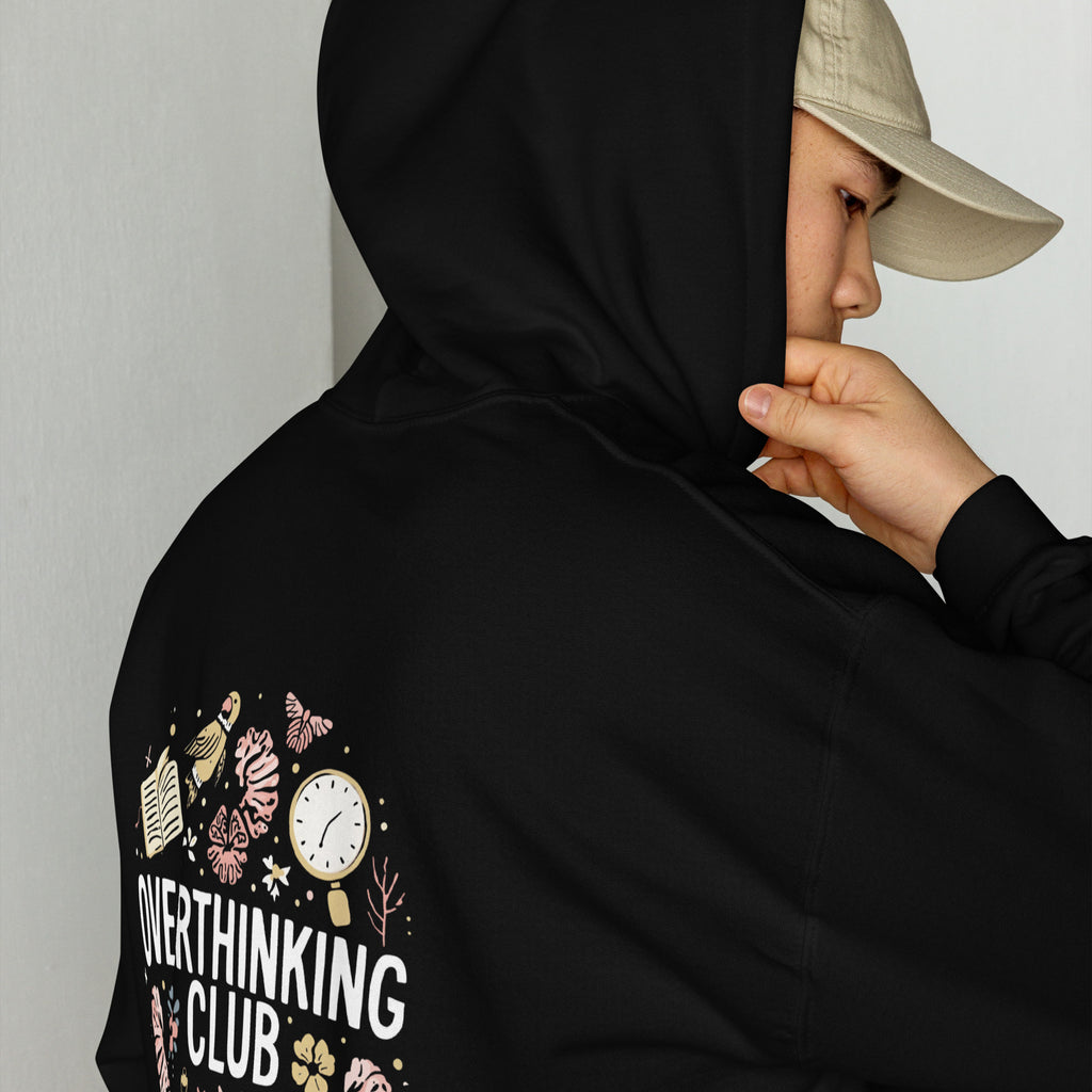 Person wearing a black hoodie with 'Overthinking Club' design on the sleeve, against a plain background.