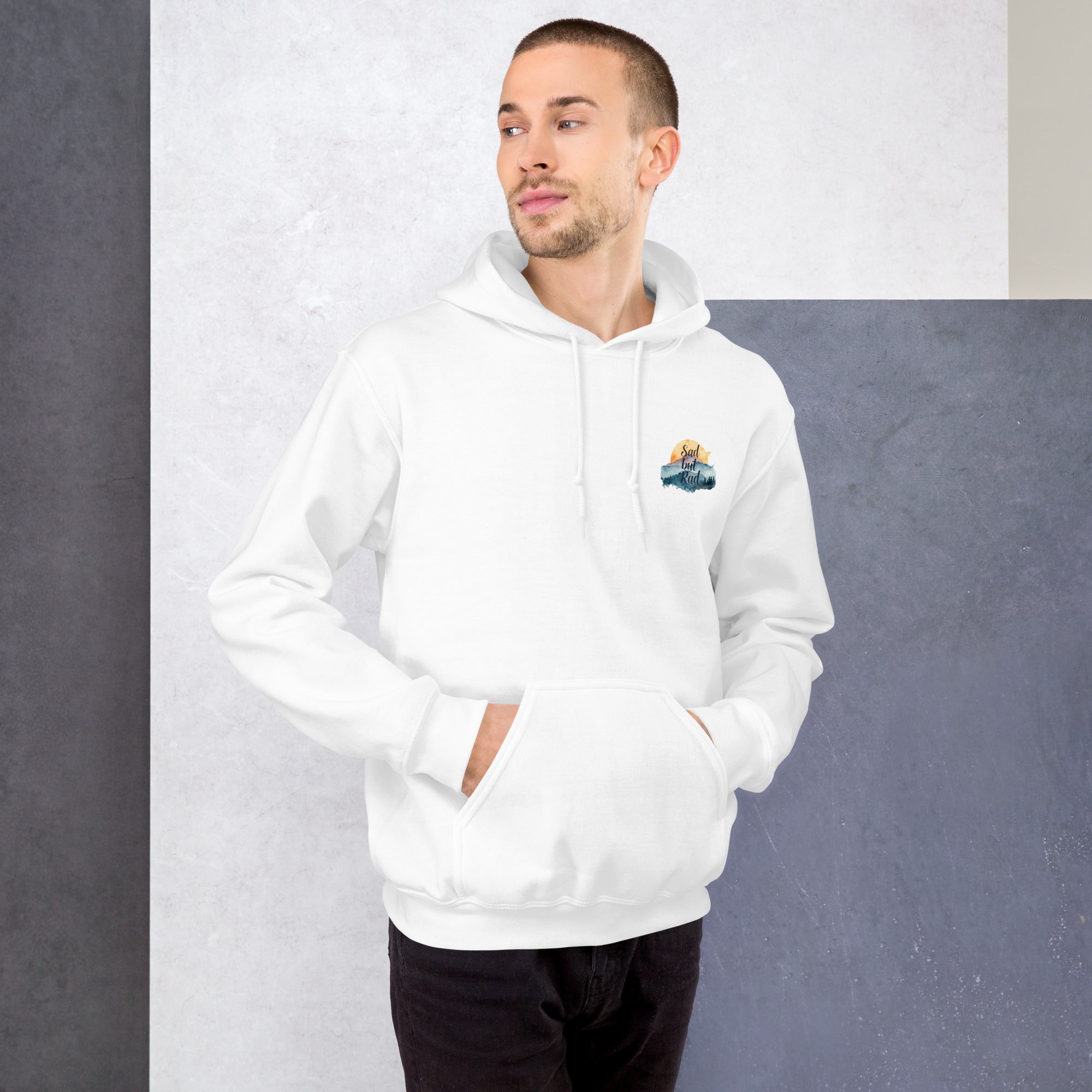 Man wearing a white hoodie with a small logo on a gray background
