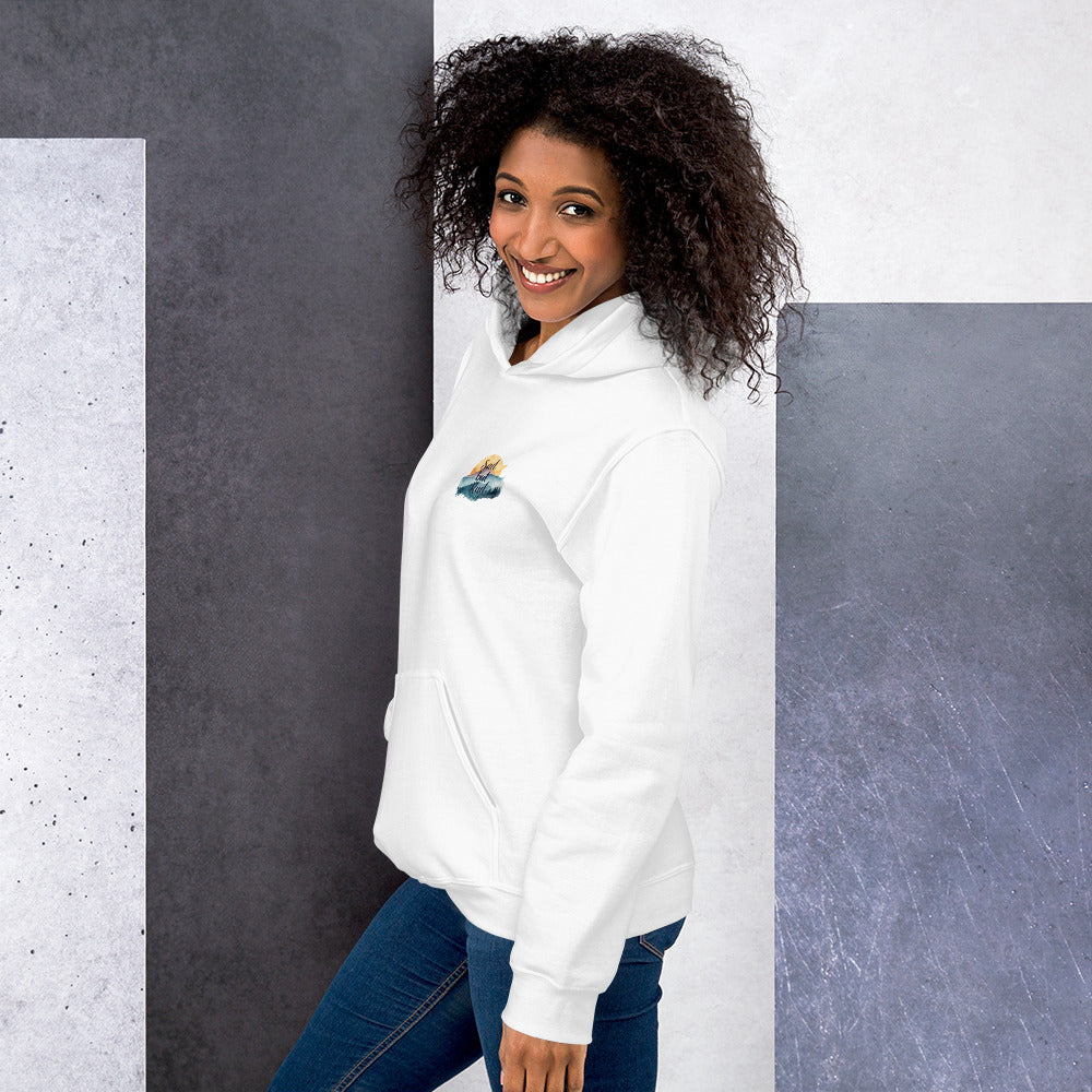 Woman wearing a white hoodie with a logo against a gray and white background