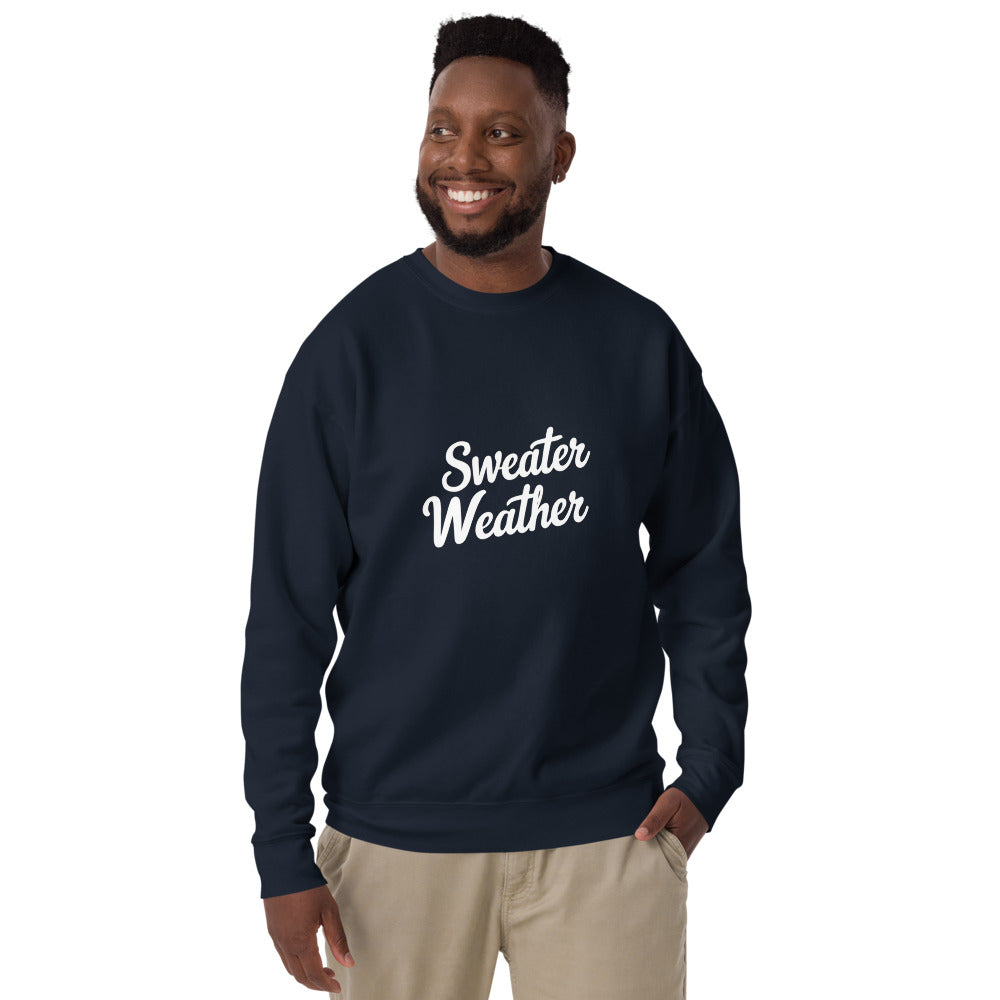 Man wearing a navy sweatshirt with 'Sweater Weather' text on a white background