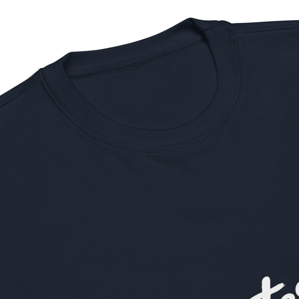Close-up of a navy blue shirt with a brand logo on a white background