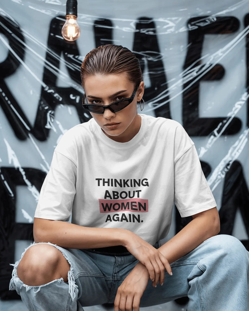 Thinking About Women Again slogan printed on a unisex t-shirt, bold queer typography on a neutral background