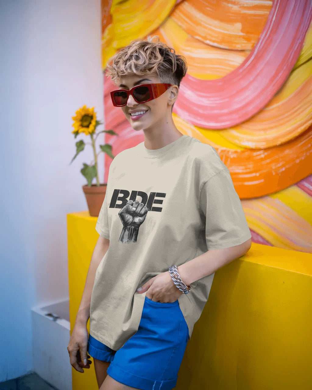 Masc lesbian wearing oversized BDE queer slogan t shirt