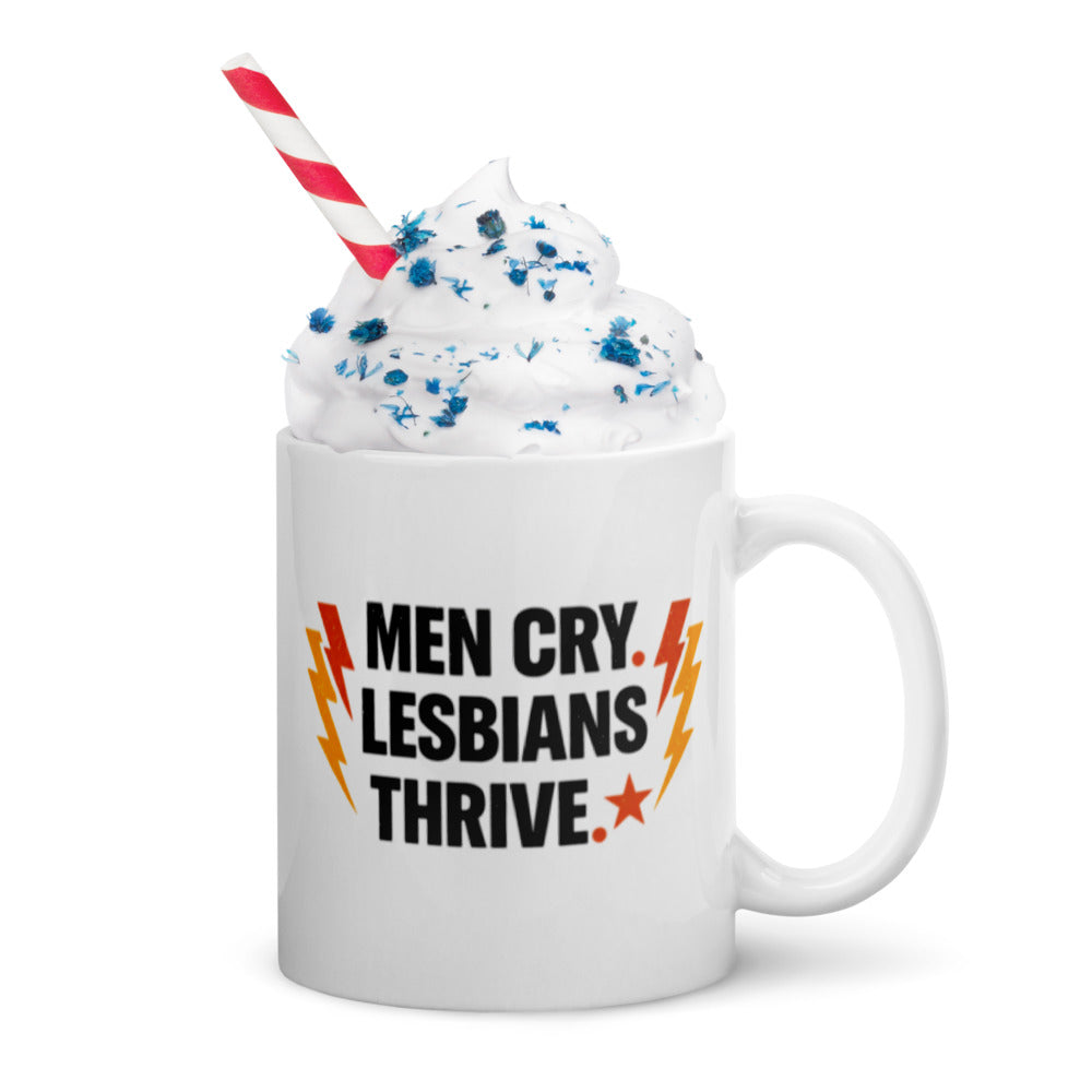 Men Cry, Lesbians Thrive slogan printed on a white ceramic mug with bold typography