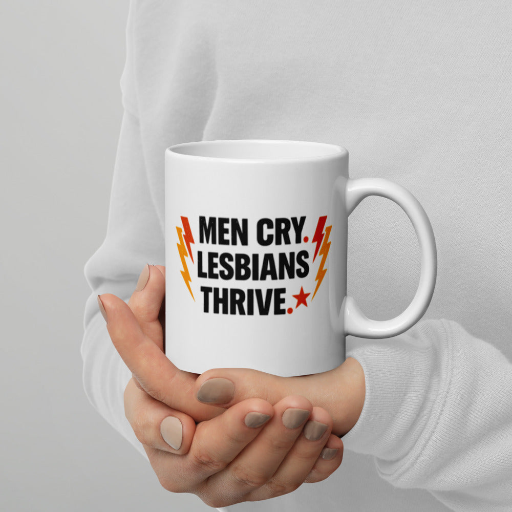 Men Cry, Lesbians Thrive slogan printed on a white ceramic mug with bold typography