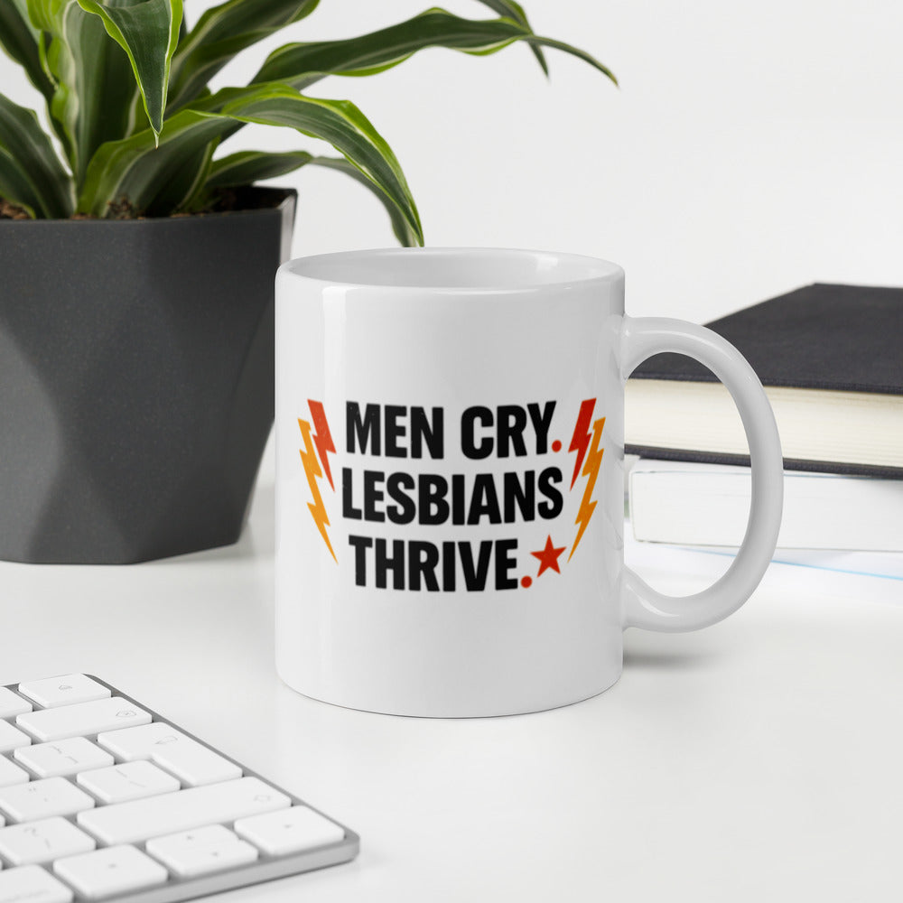 Men Cry, Lesbians Thrive slogan printed on a white ceramic mug with bold typography