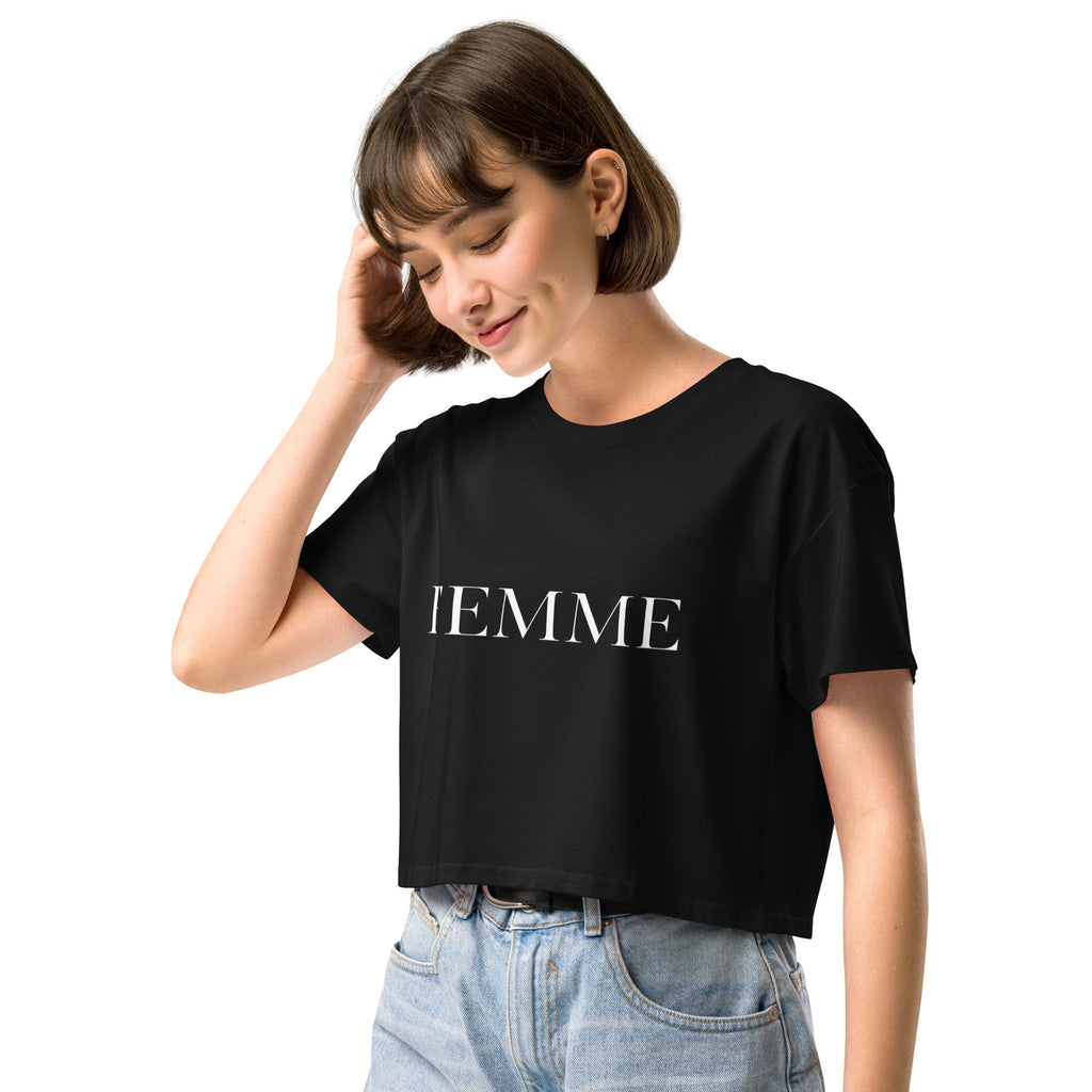 Queer femme model wearing a white FEMME crop top, minimal bold typography