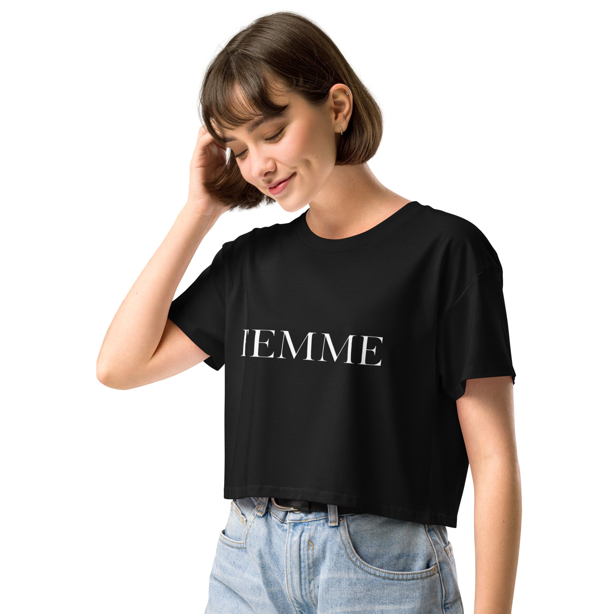 Queer femme model wearing a white FEMME crop top, minimal bold typography