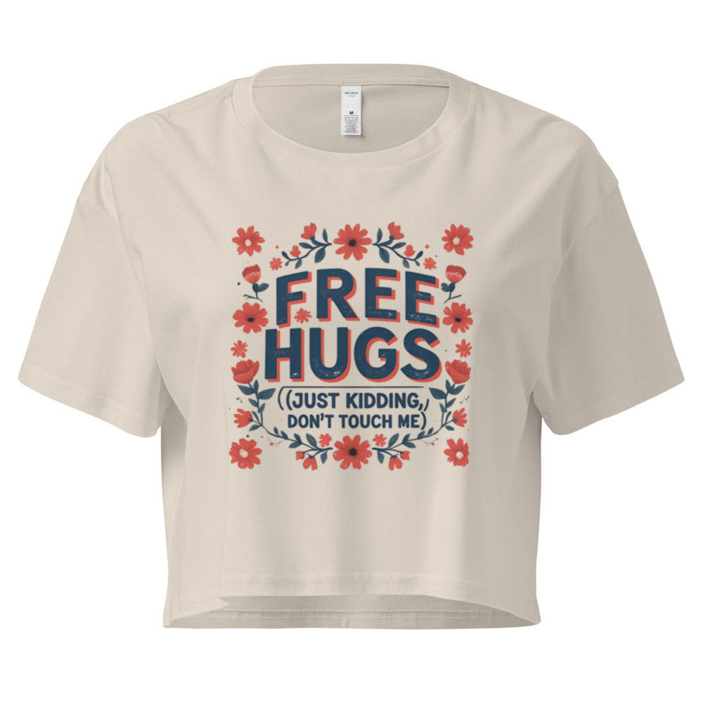 Beige t-shirt with 'Free Hugs (Just Kidding, Don't Touch Me)' text and floral design on a white background