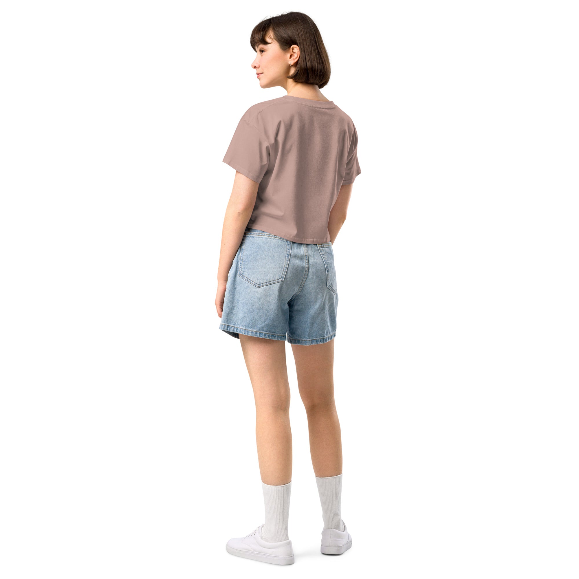 Model wearing Don’t Worry Babe, It’s Mutual cropped slogan T-shirt by Savage Cotton in lilac, styled with shades and a knowing smirk