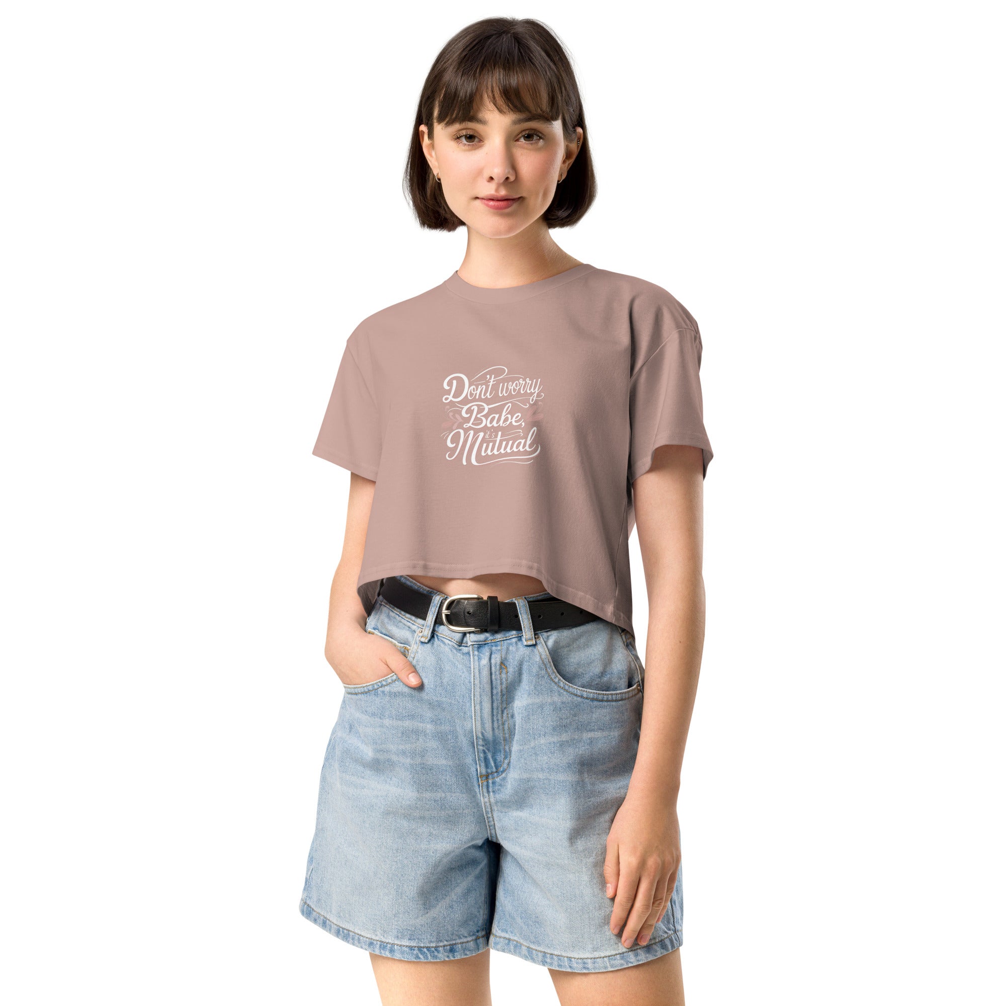 Model wearing Don’t Worry Babe, It’s Mutual cropped slogan T-shirt by Savage Cotton in lilac, styled with shades and a knowing smirk