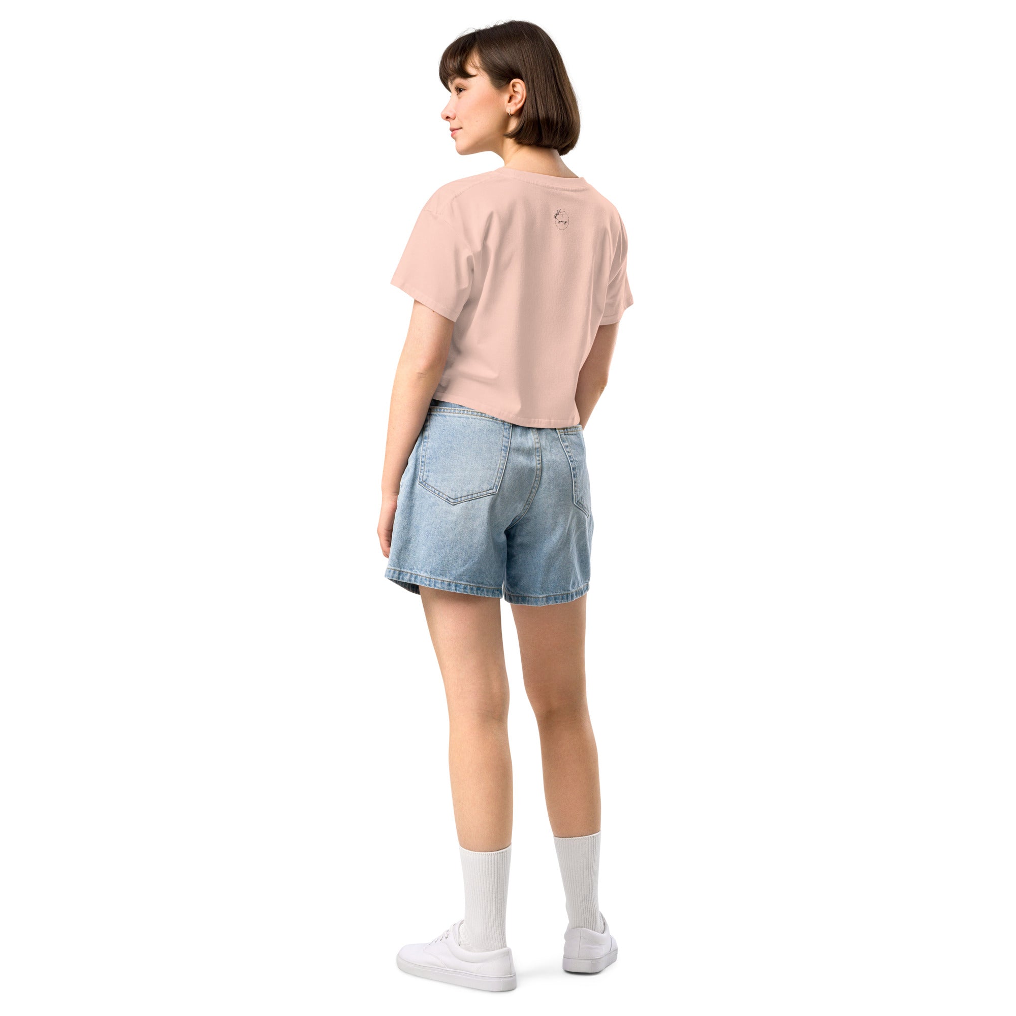 Model wearing Sip Margaritas, Spill Tea, Repeat cropped slogan T-shirt by Savage Cotton in pastel pink, styled with sunglasses and cocktail in hand